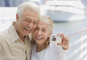 Senior Couple Using Digital Camera at Marina